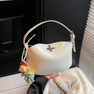 White glossy square crossbody bag with pearl handle and cute doll charm detail