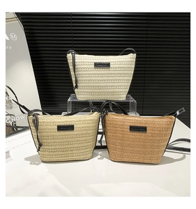 Three variants of woven straw bucket bags with black straps in beige khaki and brown colors