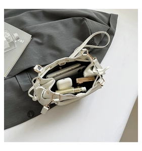 Top view of a white drawstring bucket bag showing spacious interior with daily essentials
