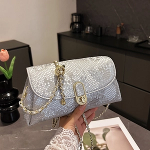 Silver snakeskin texture crossbody bag with gold chain strap and metal turn-lock