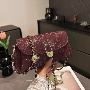 Fashionable burgundy snake pattern crossbody bag with gold chain and ring twist lock