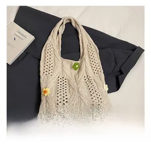 Close-up of cream crochet tote bag with handmade 3D floral accents in yellow and green