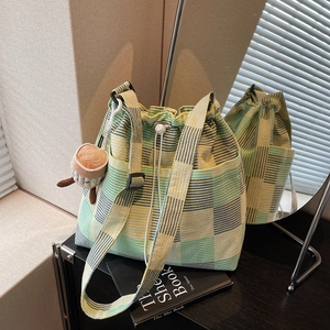 Large capacity plaid canvas bucket bag with drawstring closure and plush cup pendant