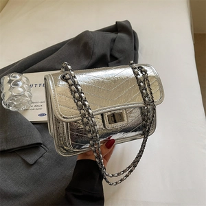 Silver metallic chain shoulder bag with quilted V-pattern and elegant metal turn-lock
