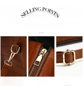 Detail of brown crocodile pattern tote bag with gold metal hooks and adjustable strap buckle