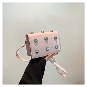 Pink patent leather crossbody bag with silver studs and quilted diamond pattern