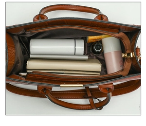Top view of brown embossed tote bag interior showing large capacity and zipper compartments