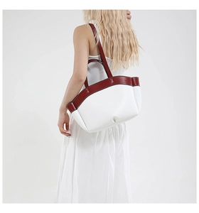Detail of a white and burgundy contrast tote bag with spacious interior for daily use
