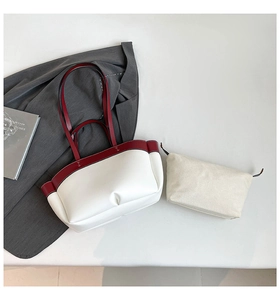 Detailed view of white tote bag set with burgundy trim and canvas insert