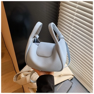 Detailed close-up of light blue lychee pattern faux leather on a versatile crossbody bag