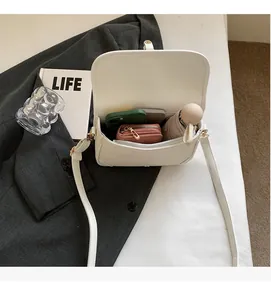 Internal view of the white leather saddle bag showing ample space for daily essentials