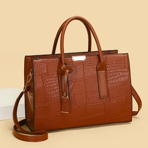Brown crocodile embossed tote bag with gold metal hardware and adjustable shoulder strap