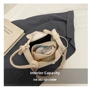 Detailed view of the large capacity interior of this chic beige leather shoulder bag