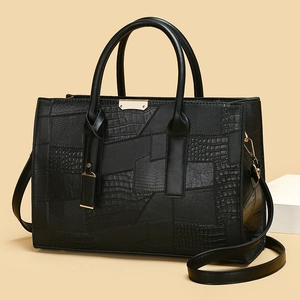 Chic black tote bag with geometric faux crocodile textures and gold metal clasp hardware