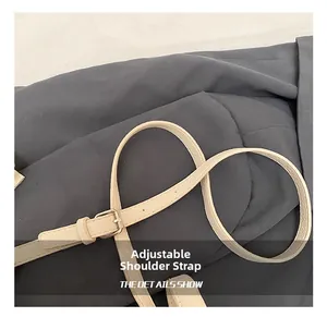 Detail of adjustable beige faux leather strap with litchi texture and metal buckle