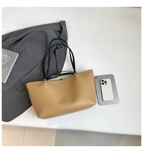Minimalist beige tote bag shown with daily essentials and office wear on white surface