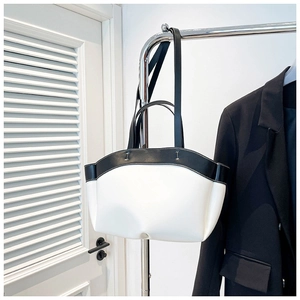 Chic black and white leather hobo bag with minimalist semicircular design for women
