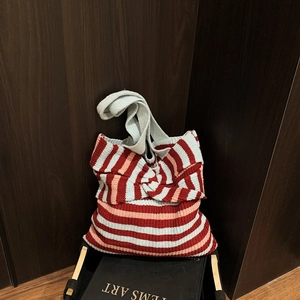 Chic knit striped tote bag with red, pink, and blue patterns and a bow design