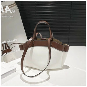 Minimalist white and brown leather tote bag with top handle and adjustable shoulder strap