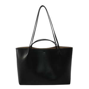 Minimalist black leather tote bag with dual handles and spacious interior shown on white background