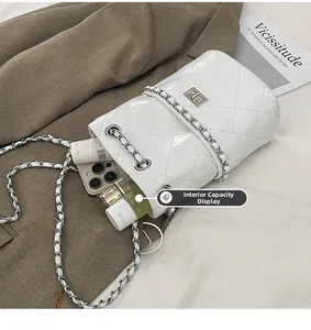 Interior view of white quilted bucket bag showing ample space for phone and perfume