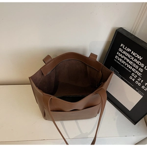 Top view of large brown tote bag with litchi grain texture and spacious interior
