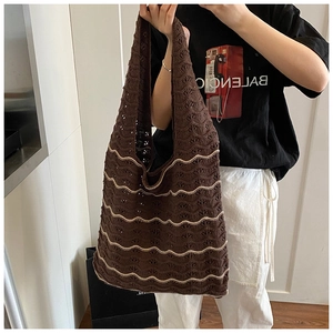 Close-up of handmade crochet weaving details on the brown bohemian shoulder bag