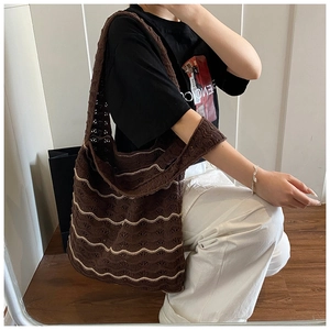 Detail of coffee brown knitted tote bag featuring stylish white wavy crochet patterns