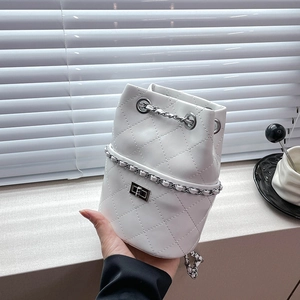 White quilted drawstring bucket bag with silver chain strap and metal buckle detail