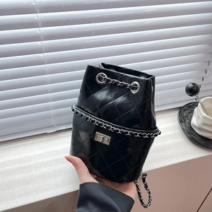 Chic black quilted drawstring bucket bag with silver metal chain and twist-lock clasp