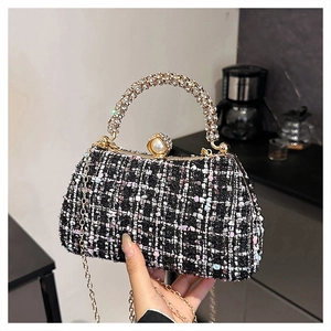 Detail of pink and black tweed evening bag with rhinestone handle and pearl clasp