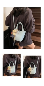 Detail of light blue lychee leather bucket bag with teddy bear charm and silk scarf