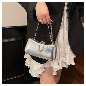 Detail of silver metallic evening clutch bag with rhinestone buckle and chain strap