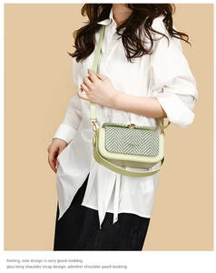 Detail of light green leather crossbody bag with chic houndstooth pattern on the flap