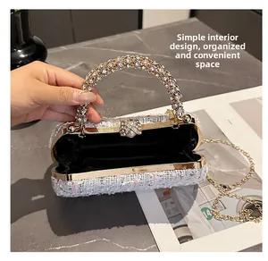 Detail of tweed evening bag showing open black interior lining and luxury pearl bow clasp
