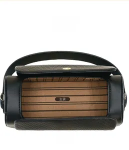 Detail of black barrel bag showing spacious main compartment with brown striped lining