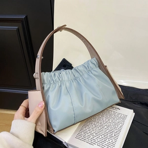 Light blue ruched underarm bag with brown leather straps and silver metal hardware