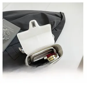 Vue détaillée du grand compartiment intérieur du sac à main blanc en cuir à rabat