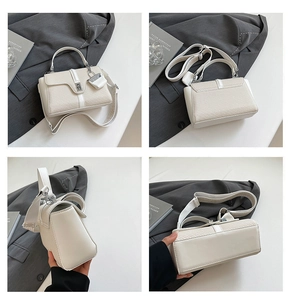 Vue détaillée du sac à main tissé blanc crème avec large bandoulière et fermoir argent