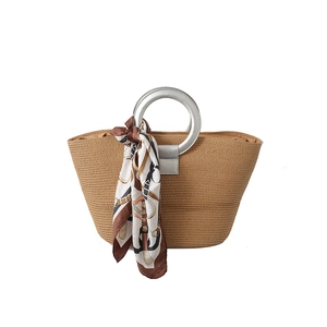 Large woven tote bag with silver round handles and printed silk scarf on white background
