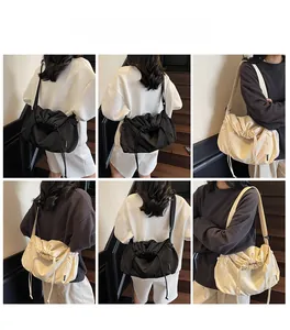 Detail view of large capacity drawstring shoulder bag in black and off-white colors