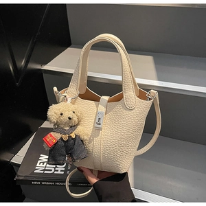 Chic cream white lychee leather bucket bag with puppy charm and silver lock detail