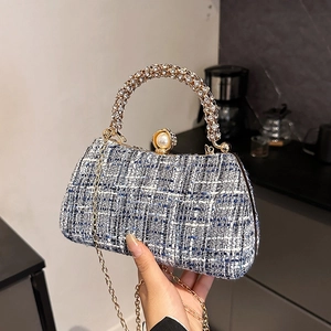 Elegant tweed evening bag with sequin chain and rhinestone ring handle shown in hand