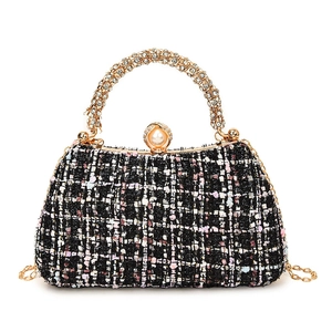 Elegant tweed evening bag with shimmering crystal handle and large pearl clasp detail