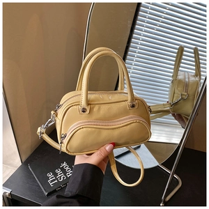 Fashionable cream yellow PU leather boston handbag with silver zippers and shoulder strap