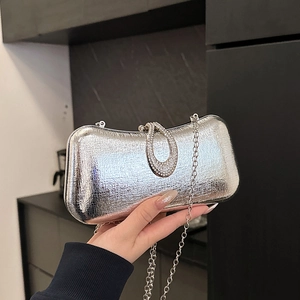 Silver metallic evening clutch bag with rhinestone ring clasp and silver chain strap