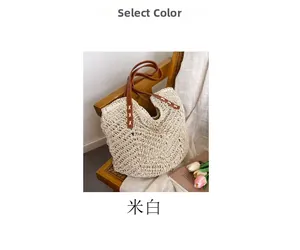Detail of off-white hollow straw tote with brown leather handles and hand-stitched seams