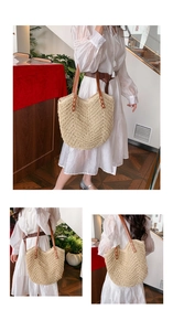 Detail of hand-woven straw tote bag showing brown leather straps and wave texture