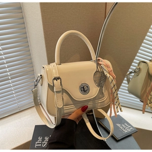 Minimalist beige PU leather handbag with silver lock and decorative tennis racket charm