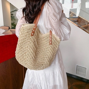Minimalist hollow straw tote bag with brown leather handles for bohemian summer style